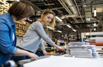 Professional female employees working in a printing house